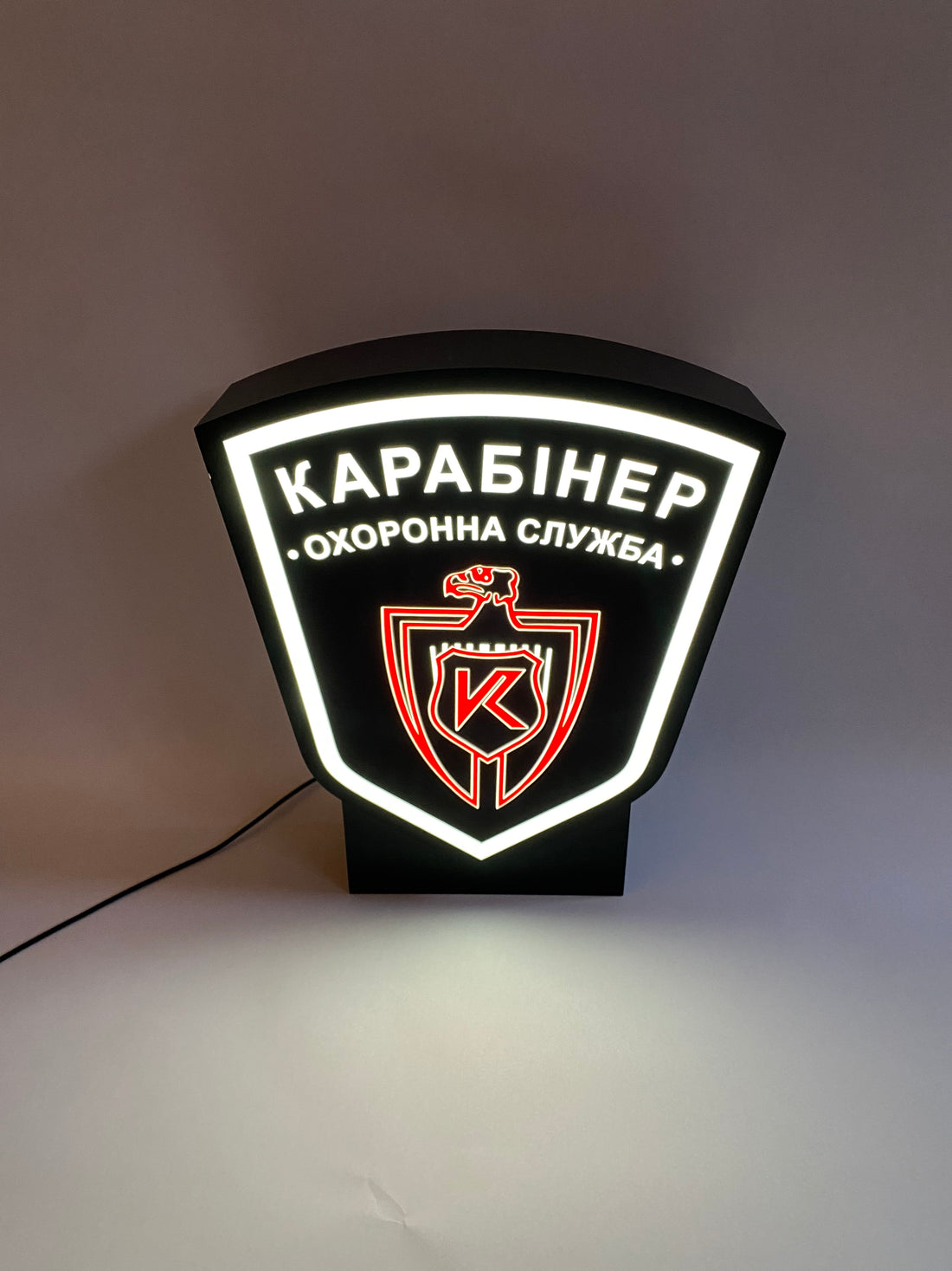 A lamp in the shape of a coat of arms with your image on a stand (height 35 cm)