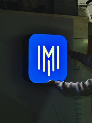 A lamp in shape of app icon with your logo/text