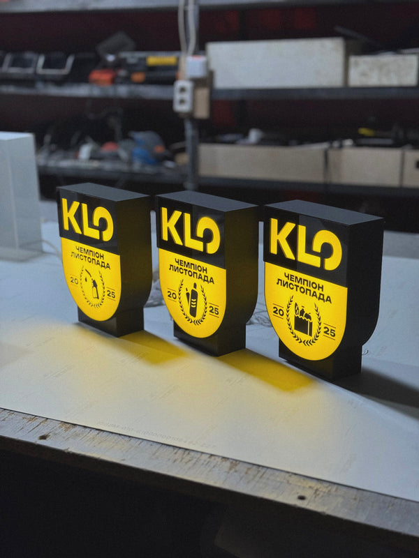 A lamp in the shape of a coat of arms with your image on a stand (height 25 cm)