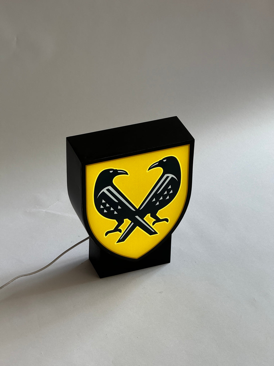 A lamp in the shape of a coat of arms with your image on a stand (height 25 cm)